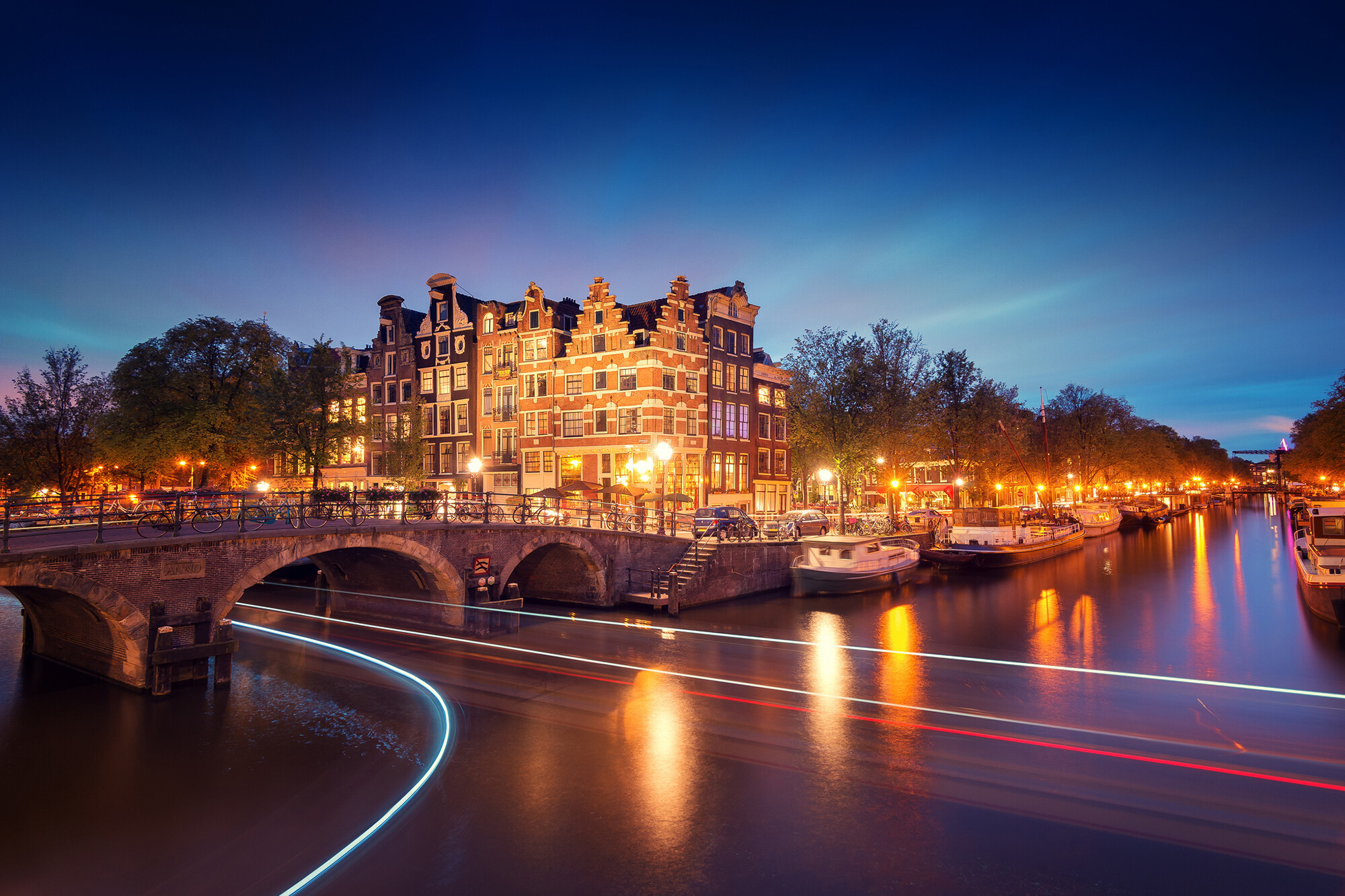 Amsterdam city lights, Canal bridge, River boats, Trees wallpapers, 2000x1340 HD Desktop