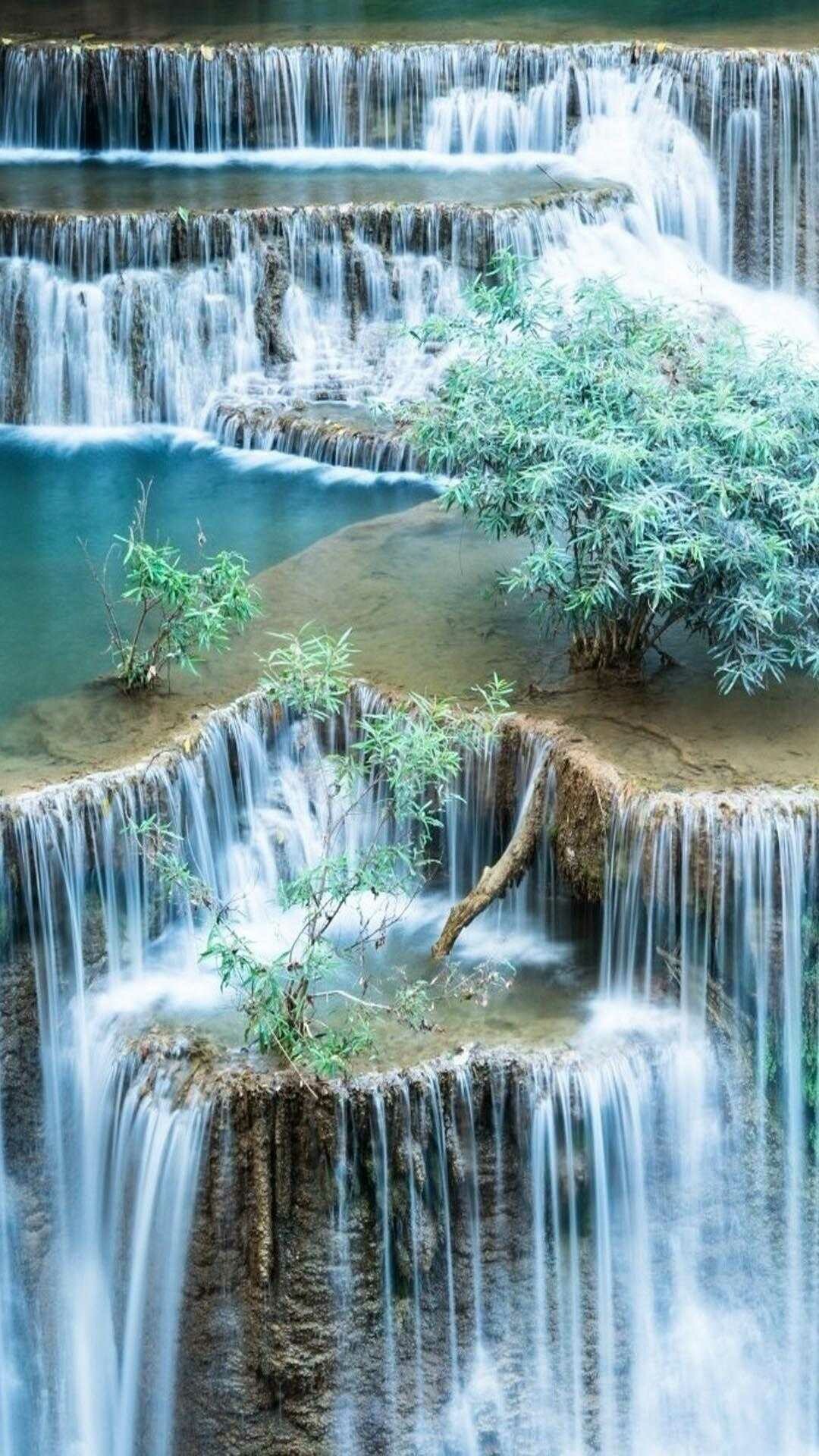 Mesmerizing waterfall, Tranquil oasis, Serene ambiance, Natural artistry, 1080x1920 Full HD Phone